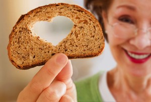 Mature woman holding whole grain bread